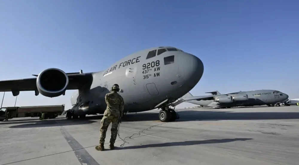 US lowers security alert at Qatar air base, sources say